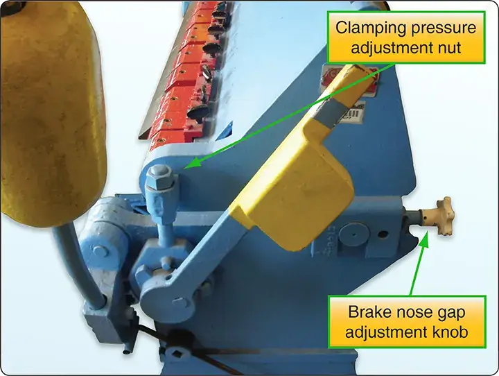 Clamping pressure nut adjustment on a sheet metal brake for securing metal during bending