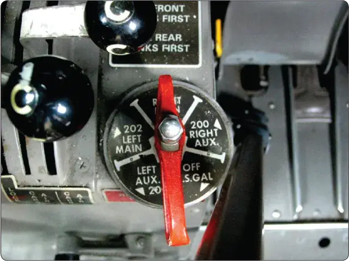 Aircraft fuel selector valve with detents, position indicator handle, and labels for pilot control