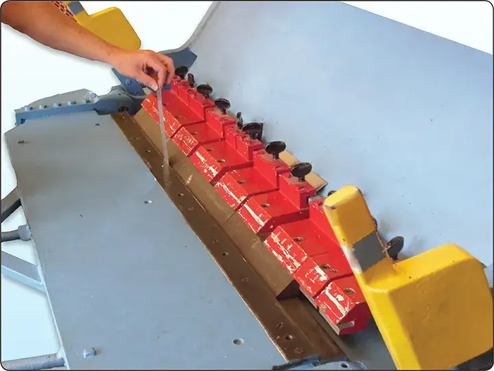 Sheet metal brake nose gap adjusted using material of the same thickness as the part being formed