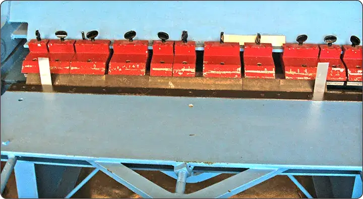 Sheet metal brake alignment checked using two test strips bent to 90 degrees