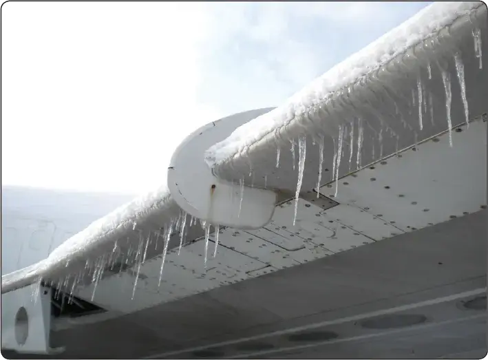 Ice accumulation forming along an aircraft wing leading edge during flight in icing conditions