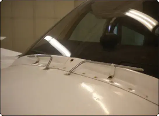 Chemical deicing spray tubes positioned to distribute deicing fluid across an aircraft windshield surface