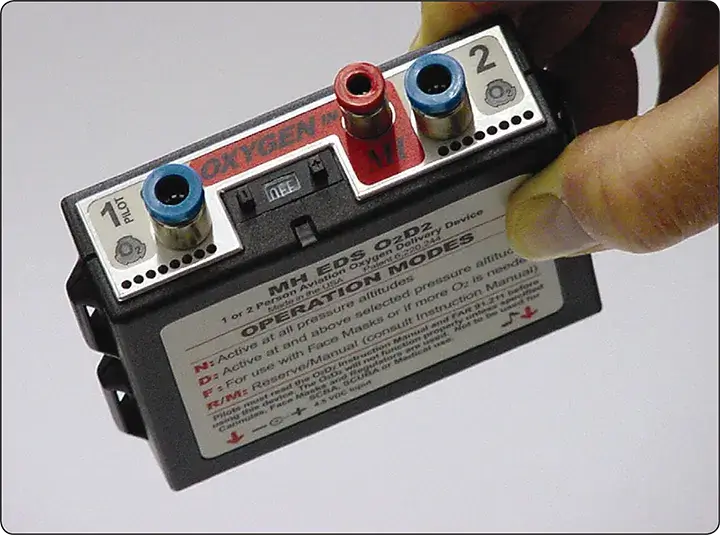 Portable electronic oxygen regulator designed to deliver pulse-demand oxygen to two users