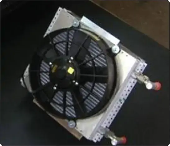 Vapor cycle air conditioning condenser assembly with an integral fan for drawing outside air through the condenser during ground operation