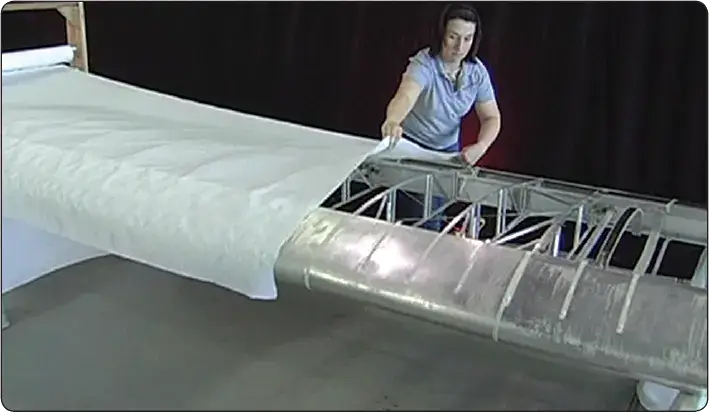 Aircraft fabric being laid out during a blanket-method re-covering process