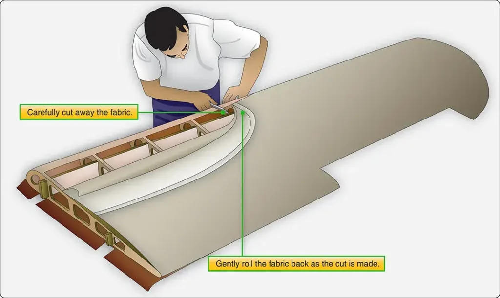 Old aircraft fabric covering being carefully removed in large pieces for use as templates