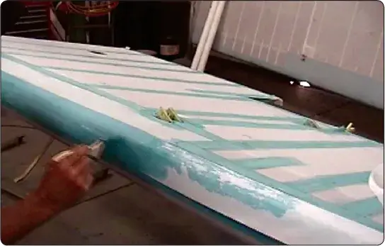 Cement applied through four-inch tape over a wing leading-edge seam with two-inch rib tapes covering wing ribs and lacing