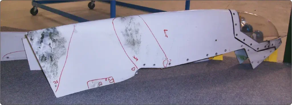 Erosion damage to an aircraft wingtip showing wear of the composite surface