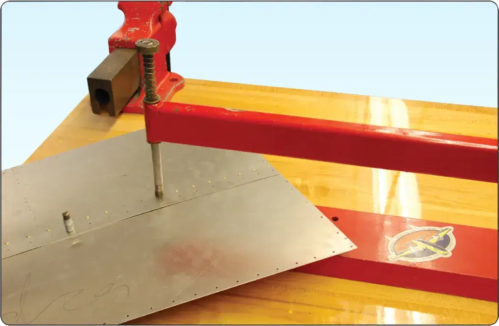 Table riveter used to install solid shank rivets in aircraft sheet metal