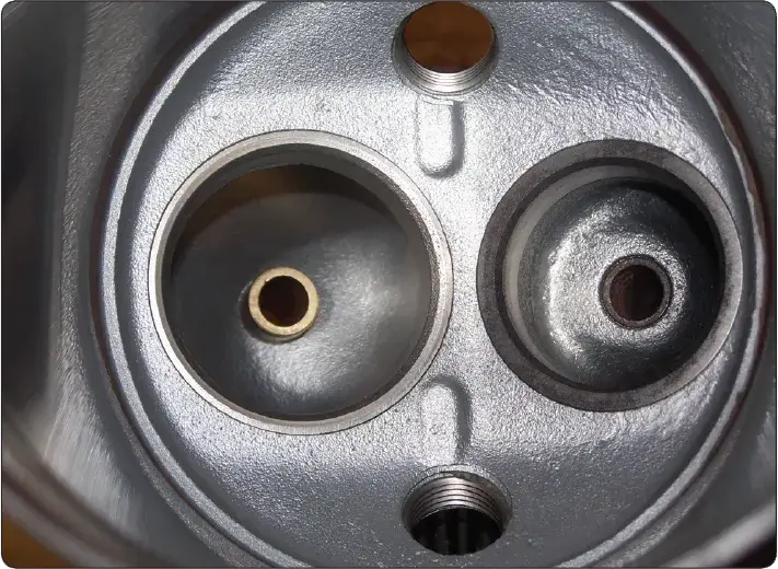 Valve guide installed in an aircraft reciprocating engine cylinder head.