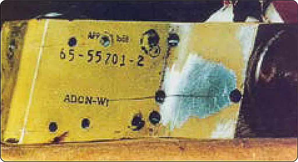 Close-up of stress corrosion cracking in a metal component, showing cracks that develop through the combined effects of tensile stress and a corrosive environment