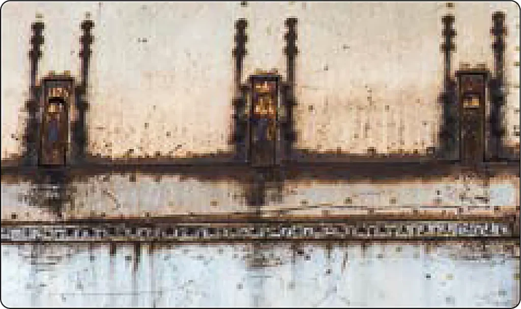 Metal joint showing galvanic corrosion near the contact between dissimilar metals exposed to an electrolyte, resulting in localized material deterioration