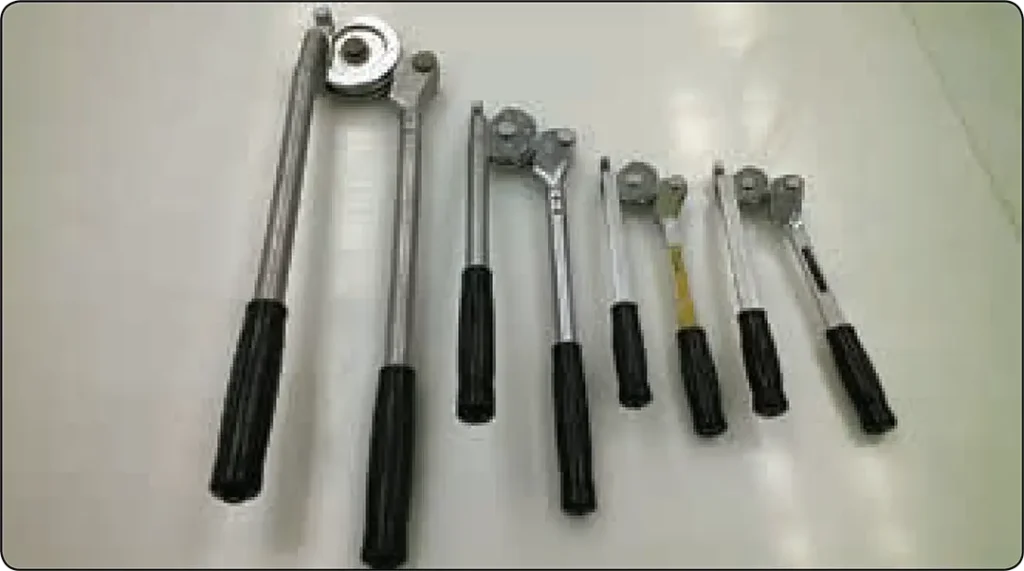 Hand-operated tube benders used to form accurate bends in aircraft rigid fluid lines while minimizing flattening and kinking
