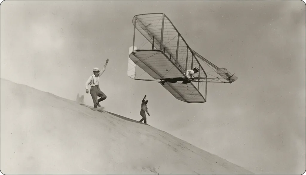 Orville and Wilbur Wright’s Wright Flyer in flight over the Kitty Hawk dunes on December 17, 1903, during their pioneering powered flight