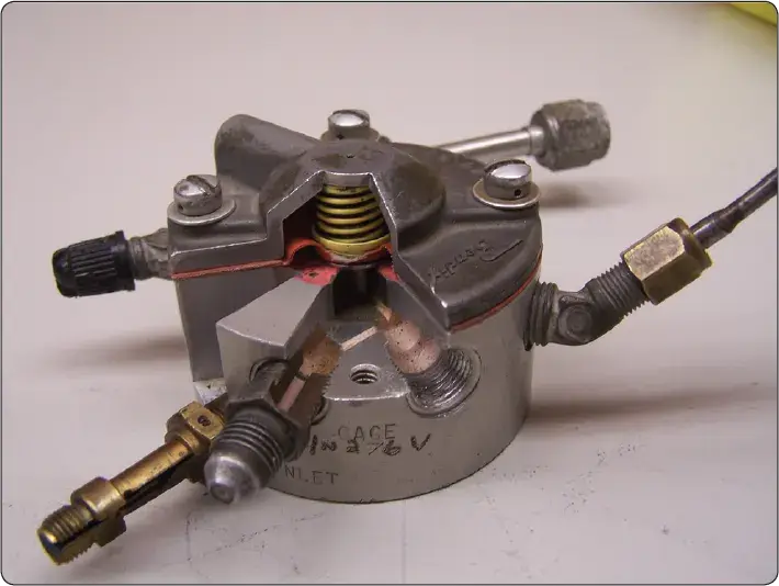 Cutaway view of a fuel flow divider showing its internal components and fuel distribution passages