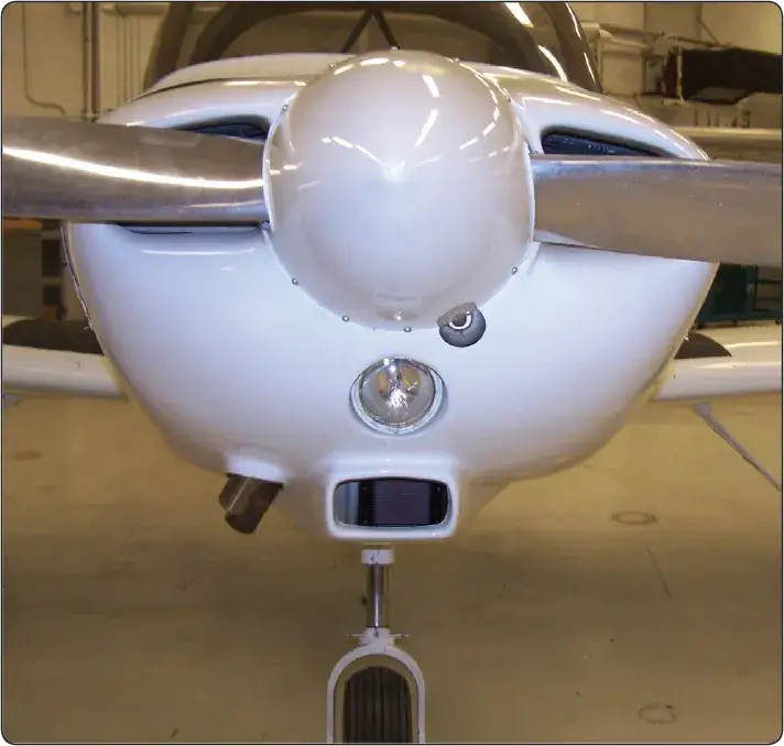 Engine cowling with an inlet scoop designed to direct outside air into a reciprocating engine induction system