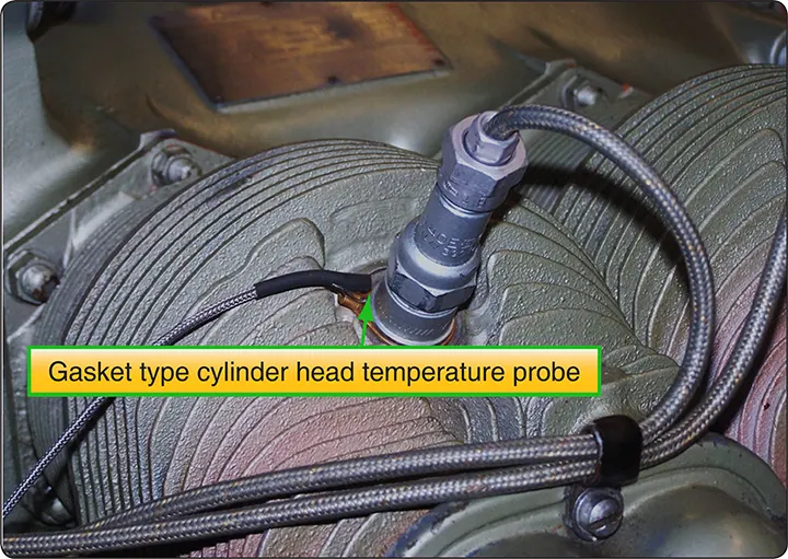Gasket-type cylinder head temperature (CHT) probe installed at the cylinder spark plug location to monitor an aircraft engine's operating temperature