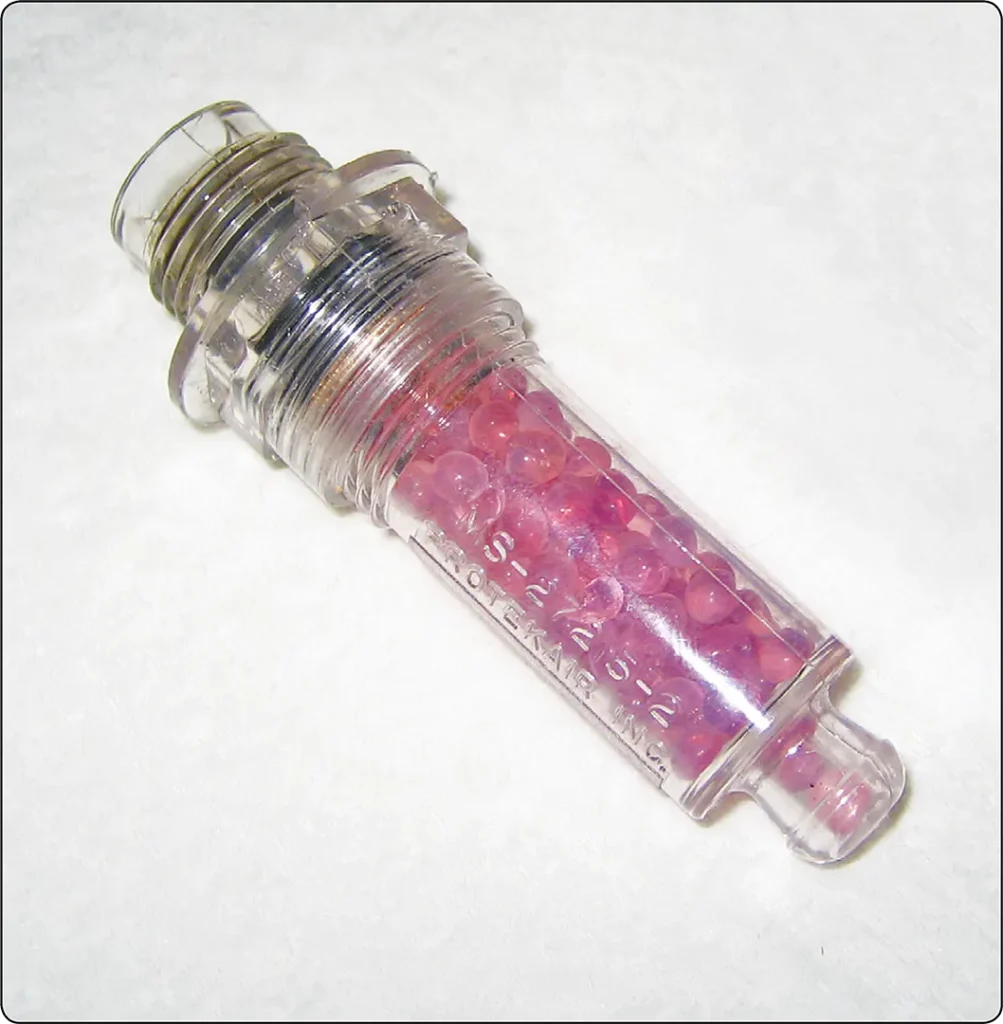 Pink dehydrator plug indicating high humidity inside an aircraft engine during preservation and storage