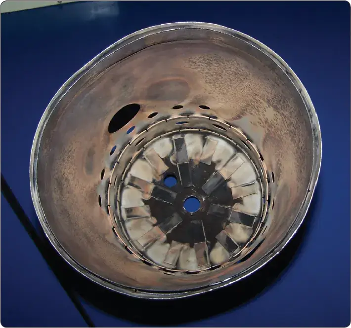 Interior view of a gas turbine combustion chamber liner showing the internal combustion area and cooling features